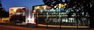 A building is illuminated at night.