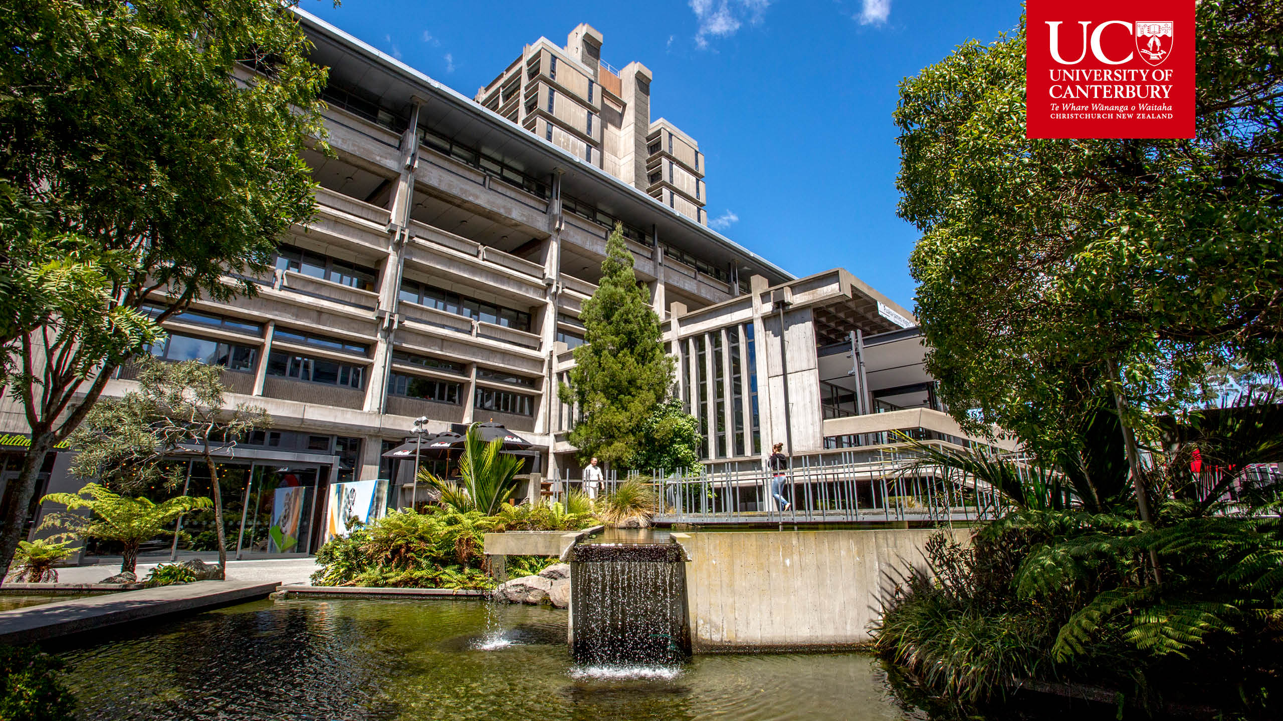 A building with a fountain in front of it on the University of Canterbury campus.